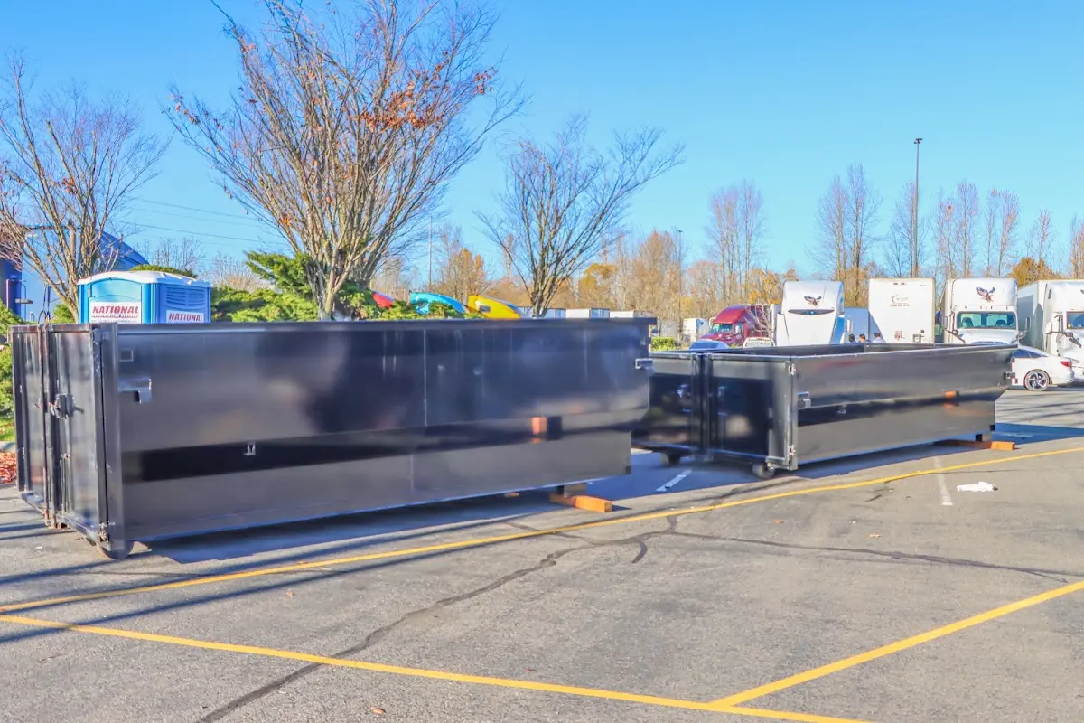 Professional dumpster rental service with roll-off container on residential driveway in Massanetta Springs